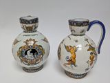 pair of vases with blue handles on a white background