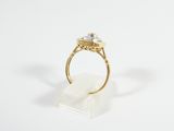 an image of a gold ring with a white diamond on it