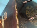 a black and gold box with handles on a wooden table