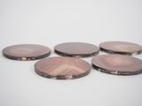 six pink agate coasters sitting on top of a white surface