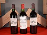 trois bouteilles de vin posées l'une à côté de l'autre sur une table
