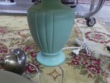 a lamp that is sitting on a rug on the floor
