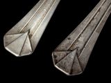 two spoons that are sitting next to each other