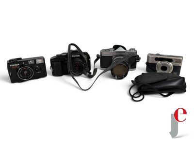 four cameras and a bag on a white surface