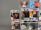 a lot of pop vinyl figures on display in a display case