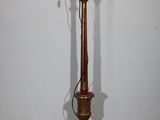 a lamp that is sitting on the floor next to a wall
