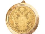 l'image d'une pièce d'or sur laquelle figurent des armoiries