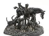 a statue of a man on a horse with a group of dogs