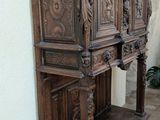 a wooden cabinet with carvings on the top of it