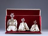 two dolls are in a box with a red cloth
