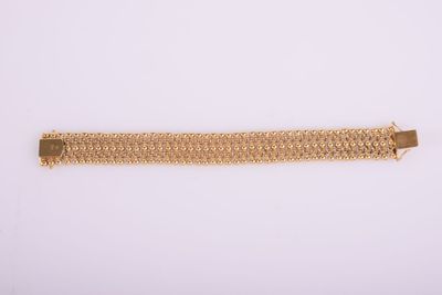 a gold bracelet on a white background