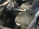 the interior of a car with the door open and the driver ' s seat down