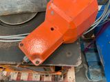 an orange machine that is sitting on top of a pallet