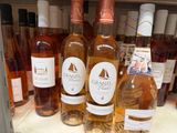 many bottles of wine sitting on a shelf in a store