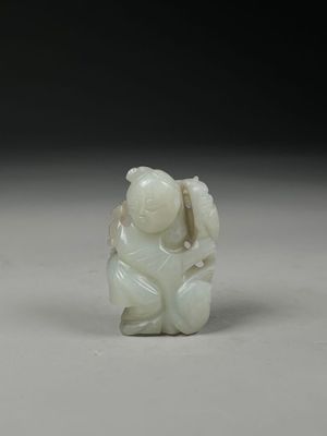 chinese carved jade figurine of a boy holding a fish