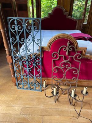a bed with a red blanket and a red chair in front of it