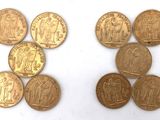 six different types of gold coins are shown on a white surface