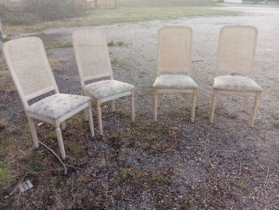 four chairs are sitting in a row on the ground