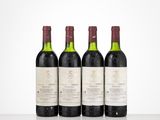 three bottles of wine are lined up on a table