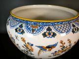 a white bowl with blue and yellow designs on it