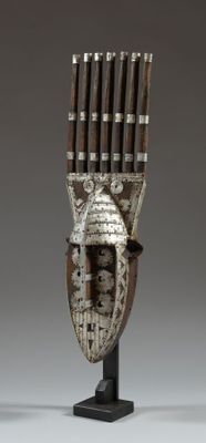 an image of a sculpture of a wooden mask on a stand