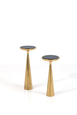 pair of brass pedestals with black marble top on a white background