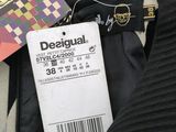 a label on a black jacket that says desigual