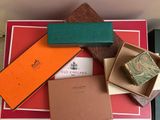 several boxes of different colors and designs are stacked on top of each other