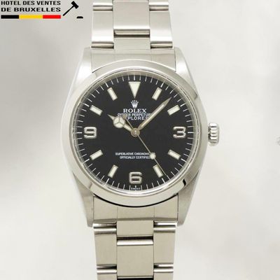 rolex watch with black dial and black face on a stainless steel bracelet
