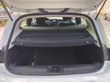 a trunk of a white car with its doors open