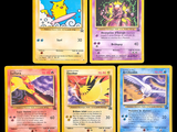 four pokemon cards of different colors and designs on a black background