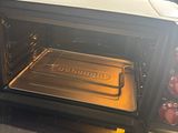 a toaster oven with a tray of food inside of it
