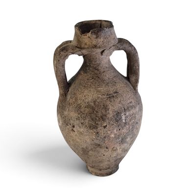 an old vase that is sitting on a white surface