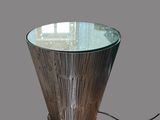 a table that has a glass top and a metal base