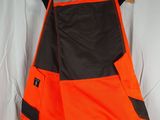 a close up of an orange and black shorts hanging on a hanger