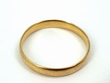 an image of a close up of a gold ring on a white surface