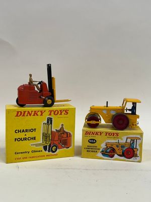 two toy tractors sitting next to each other on a table