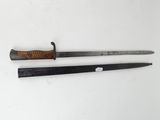 two swords with a wooden handle on a white surface