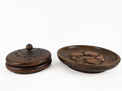 two wooden bowls with lids and lids are sitting on a white surface