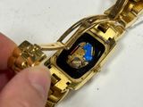 a person that is holding a watch in their hand