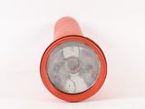 a red flashlight that is sitting on a white surface