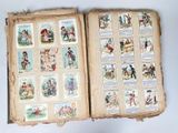 an open book with pictures of people and animals on it