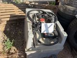a box with a bunch of wires on it next to a pile of tires