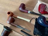 many different types of smoking pipes on the table