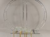 an image of a glass table and four chairs in front of a circular mirror