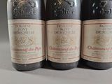 three bottles of wine are lined up on a table