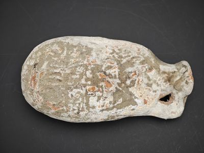 une image représentant un objet en pierre posé sur une surface noire