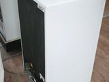 an image of a small white refrigerator in a room
