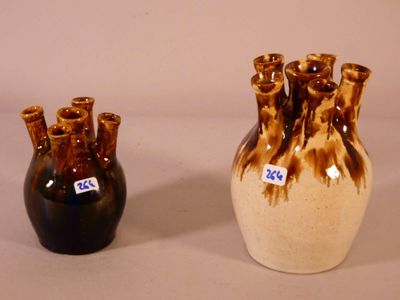 two vases sitting next to each other on a table
