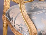 a gold and blue chair with a blue and white upholstered seat